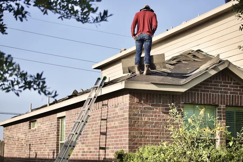 Professional roofer working on a residential roof in Moxley Acres